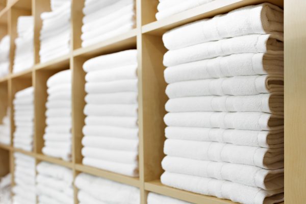 white towels stacked in cupboard